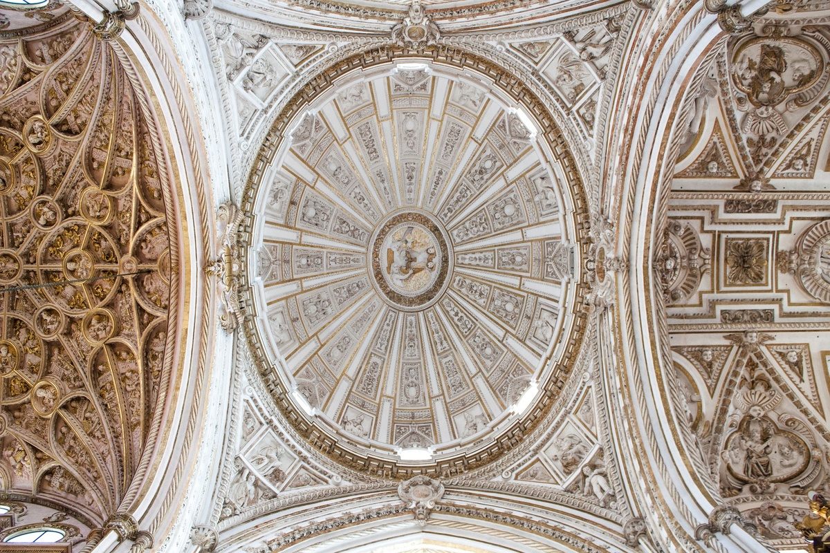 The carved white dome of a historic Spanish ceiling